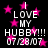 Black background with pink stars and white text reading "I LOVE MY HUBBY!!! 07/28/07" in a pattern