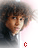 A pixelated portrait of a person with curly hair, wearing dark clothing against a light background, with red text elements changing across frames.