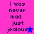 A static image with a bright pink background displays the text "i was never mad just jealous" in dark blue pixelated font, each line stacked vertically.