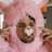 A person in a pink furry costume with an orange nose and white mouth area, next to black background text reading "What the Fuck's a Furry?".