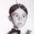 Pixelated grayscale image of a person with short dark hair wearing a bow tie, next to pixelated text reading 'aLfa Lfa! <3' on white background.