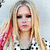 six pixelated images showing a person with long blonde hair in various poses and outfits, including a checkered shirt, white top, and black top, with a pink background and text