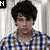 six pixelated images showing a person with curly brown hair in various poses and backgrounds, including checkered shirt, purple patterned backdrop, black-and-white scene, and plain white background