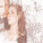 A pixelated image of a person with long brown hair holding a dark object near their face against a light background.