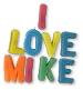 Colorful block letters spell 'I LOVE MIKE' with a red vertical bar above the 'I', set against a white background.