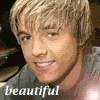 A close-up portrait of a person with light brown hair wearing a gray shirt, with the word 'beautiful' in white text at the bottom left.