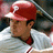 A pixelated image of a person in a red baseball helmet and white striped jersey, with pink text labels below and to the right.