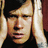 A pixelated image of a person with hands pressed against their ears, set against a black background with white text reading "no need to" above and "WHISPER AVA" below.