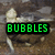 A four- displays a pixelated turtle with green text overlays reading 'BUBBLES', 'THE', 'WONDER', and 'TURTLE'