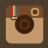 Pixelated camera icon with brown top section, beige bottom section, circular lens, and rainbow stripe on left side.