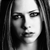 Black-and-white pixelated portrait of a person with long hair, showing partial facial features and a neutral expression.