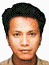 Static portrait of a person with short dark hair wearing a light-colored shirt against a white background.