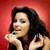A woman with long dark hair holds a phone to her ear against a red background, shown in four