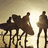 A pixelated image shows silhouettes of people on a beach at sunset with text reading "LOOVEEE" and "Surfin" in white block letters against brown background.