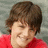 A person with brown hair wearing a red shirt appears in three showing slight head movement and expression changes