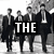 Black-and-white pixelated image of four men in suits with large text overlay reading THE BEATLES.