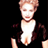 Pixelated static image of a person with light brown hair wearing a white shirt and dark jacket against black background, likely from early 2000s AIM buddy icon collection.