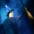 Pixelated blue background with a wizard's hat and wand, green text fragments on black