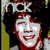 Pixelated image of a smiling face with red hair and white skin, set against a dark background with yellow vertical elements and white text at the top.