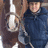 A pixelated image of a person in dark clothing holding a horse's reins, with green background and pink text listing names.