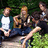 A four- with a pixelated outdoor photo of people on the top-left, red with text on top-right and bottom-left, and gray on bottom-right