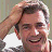 A 48x48 pixel buddy icon featuring a person with light brown hair and a gray shirt on the left, next to large black text "MEL" on the right against a white background.