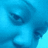 Pixelated blue-toned image with indistinct facial features and a light blue background, lacking clear subjects or text.