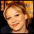 Animated sequence showing a person with light brown hair in a dark top against an orange background, transitioning from clear to pixelated text overlays.