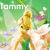 Pixelated image of a blonde fairy-like character with blue eyes, green dress, and white wings standing among flowers under the text 'Tommy' on a green background.