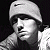 A 50x50 pixel buddy icon split into two sections: a grayscale portrait of a person wearing a beanie on the left and green text reading "Original Icons .com" on a dark green background on the right.