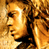 Animated contact sheet showing two frames of a golden statue-style character with long curly hair against a blue background containing text.