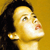 Pixelated close-up of a person's face with dark hair against a solid yellow background, rendered in low-resolution style typical of early 2000s buddy icons.