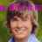 Pixelated image of a person with light brown hair and closed eyes, wearing a light blue shirt with a dark collar, overlaid with pink text reading 'Efron is ho' against a green background.