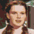 A 7-frame contact sheet of The Wizard of Oz characters with a green title banner, each frame showing distinct character expressions and costumes in pixelated animation style.