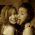 Two women in sepia-toned images with one woman's head moving closer to the other's face across frames.