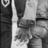 A black-and-white photo of two people holding hands appears on a pink background with green pixelated text reading "Jess" and "loves Stephen." The image is static.