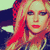 Two side-by-side pixelated images of a person with long red hair, one showing the face and upper body, the other singing into a microphone against a bright pink background.