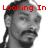 A grayscale image of a person with braided hair and facial hair, overlaid with red pixelated text reading "Looking In In A Mirror" across the top.