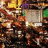 Pixelated image of a character with brown hair and purple accents, holding a green object against a blurred background with yellow text reading 'LAS VEGAS!' at the bottom.