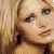 Animated pixelated image of a person with blonde hair in four quadrants, one showing red text on black background.