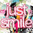 Pixelated pink text 'just smile' on a colorful abstract background with visible pixelation and partial gray overlay.