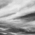 A grayscale abstract composition of horizontal bands with varying shades of gray, creating a textured, layered visual effect.