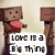 Pixelated character with brown blocky head and red heart, standing next to a wooden post; another character in pink hat and scarf appears beside text reading "COOLNESS IS NEEDED".