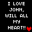 Pixelated text on black background reads "I LOVE JOHN, WILL ALL MY HEART!!" with red heart symbols in two positions.