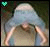 A pixelated figure with light blue hair covers its face, arms bent at the elbows in a V-shape against a dark background.