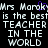 Pixelated text repeats 'Mrs Marok' with a purple heart symbol over the 'o', followed by 'is the best TEACHER IN THE WORLD' in white on black.
