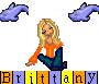 Pixelated cartoon woman with blonde hair in orange top and dark pants, seated on gray background with purple dolphin icons above her.