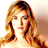 Static pixelated image of a person with long wavy hair and closed eyes against a light background.