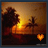 A 48x48 pixel animated buddy icon showing a sunset over water with trees, featuring two frames where the lower-right heart symbol changes from solid to empty.