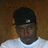 A person wearing a black cap and white shirt appears in three showing slight head movement against a brown background